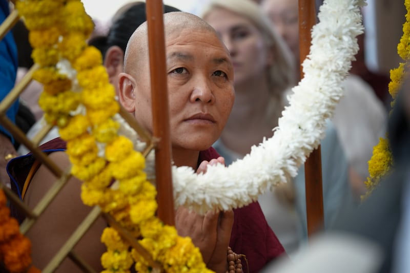 A Tibetan monk listens during celebrations on the 90th birthday of the Dalai Lama at the Main Temple in Dharamsala, India, July 6, 2025.