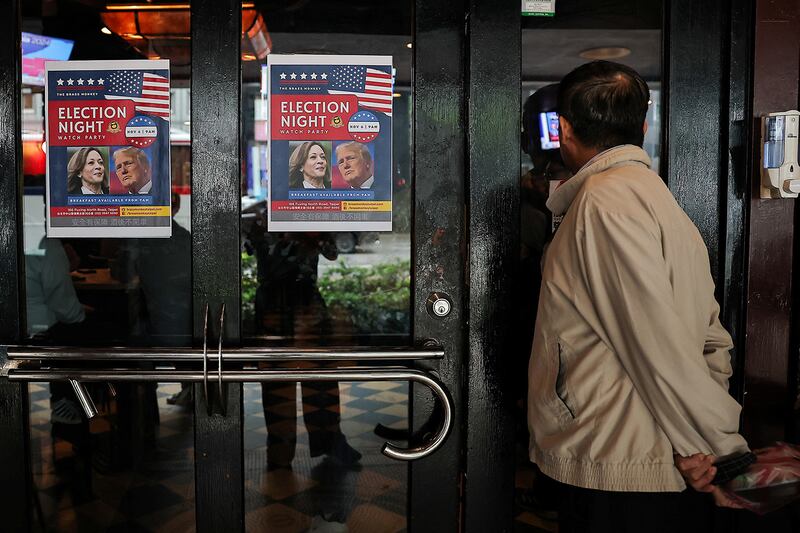 A person watches U.S. election coverage at a restaurant in Taipei, Nov. 6, 2024.
