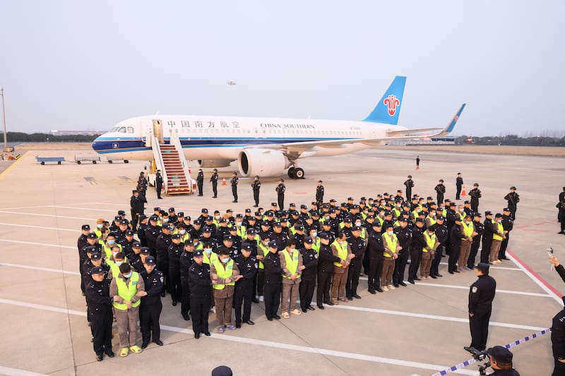 In this Feb. 20, 2025, image released by the Chinese government, a group of 200 Chinese citizens suspected of involvement in scam centers are returned to China under the escort of Chinese police after being repatriated from Myawaddy in Myanmar.