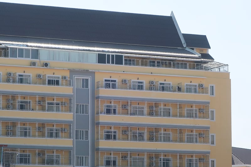 This image released by Amnesty International on June 26, 2025, as part of a report on scam centers in Cambodia shows “caged windows behind high walls of a scamming compound with three rungs of barbed or razor wire.”